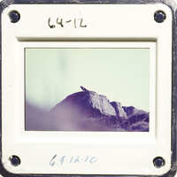 Mountain landscape with rocky terrain and hazy sky.