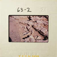 A photograph showing an outdoor scene with rocks and soil, possibly part of an archaeological excavation.