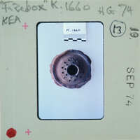 A photograph of a rusted metal object with holes, possibly an antique or historical item, dated September 1974.