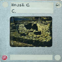 An old photograph of a stone structure with a label reading "HOUSE C" and the number "61".
