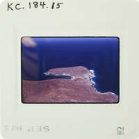 A photograph of a coastline with an island and ocean.