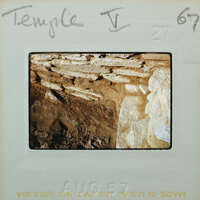 Excavated interior stone wall corner.