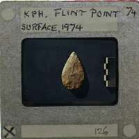 A photograph of a flint point artifact.