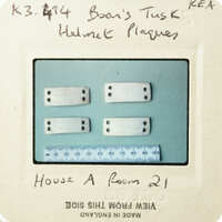 A collection of small, rectangular objects with circular cutouts on a blue background.