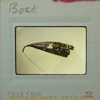 Small metal fragment of what looks to be the hull of a boat.