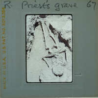 Ancient skeleton found in a cave, with bones and skull partially exposed.