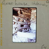 Stone-walled room interior.