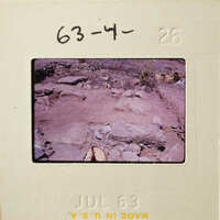 Old photograph of rocks and dirt, possibly archaeological site.