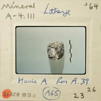 A photograph of a mineral sample labeled "Litharge" with measurement lines and annotations on an identification card.