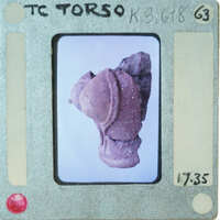 Terracotta figurine torso from side.