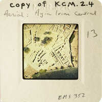 An aerial photograph of an archaeological site, possibly ancient ruins, with handwritten notes and numbers on a white background.