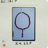 A photo of a bead necklace on a white background with an overlaid label.