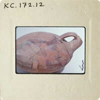 Ancient clay pot with visible cracks and imperfections.