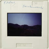 Mounted photograph of mountains and water with handwritten notes on border.