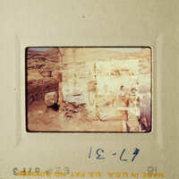 Old photograph of people and structures, possibly depicting an archaeological site.