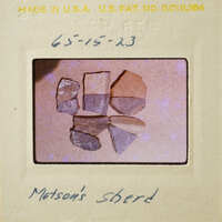 A collection of multicolored rocks on a surface.