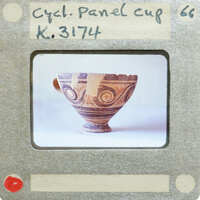 A panel cup (K.3174) with a handle and intricate patterns on display.