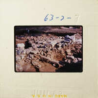 Ancient ruins with stone structures and dirt, partially excavated.