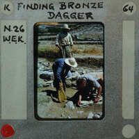 Men working on an archaeological dig, searching for bronze dagger artifacts.