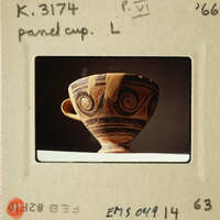 Ancient Greek style ceramic cup with intricate designs.