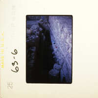 Old photograph showing an underground tunnel with stone walls and debris.