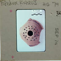 Fragment of a clay pot with holes identified as a firebox K.4203.