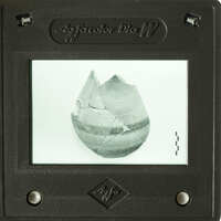 A photograph of an ancient pottery shard displayed on a projector screen.