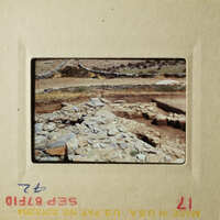 Two photos show an archeological site with stone ruins, a dirt road, and a barren landscape.