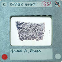 Large lumpy of shaped metal with attached label,:possibly from "House A Room".