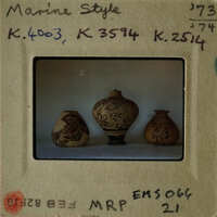 Three decorative vases on display.