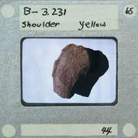 A photograph of a rock with a label indicating it's from the shoulder area, identified as B-3.261 and marked yellow.