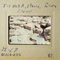 This is an old photograph of a rocky landscape with a handwritten note.