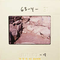 Ancient ruins with exposed rocks and stones, possibly part of an archaeological site.