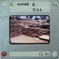 A vintage photograph of a stone ruins on an old Polaroid film with handwritten notes and numbers.