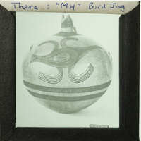 Old photograph of a vase with intricate designs, displayed in a frame.