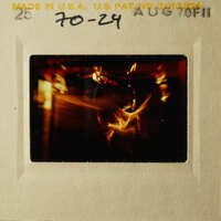 Slide with a blurry photo of a candlelit scene, possibly a birthday cake.