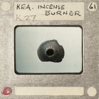 Image of an incense burner with a label on it.