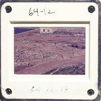 Aerial photo of an island with sparse vegetation and a body of water.