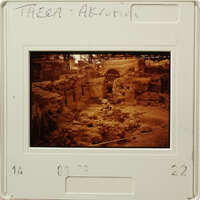 Old photograph of an archaeological site with ruins and debris.