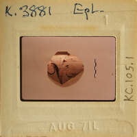 Ancient artifact with intricate designs, possibly pottery, photographed on an old slide.