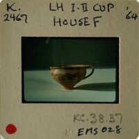 Old cup on table with vintage photo label.