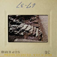 The images show two different views of an archaeological site with stone ruins and rubble.