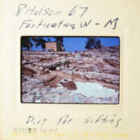 A photograph of an archaeological site with a sign indicating it as Fortification W-M, taken by Ridley H. Rhodeson.