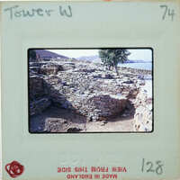 Old stone ruins of a building with vegetation growing on it, captured on an old film negative.