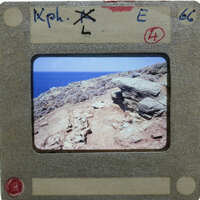 An old slide with a picture of an ancient archaeological site by the ocean.