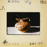 Ancient Greek vase with intricate designs on display.