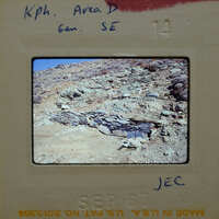 Slide of a rocky mountain landscape with a small cave or overhang.