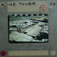 A film strip with a photograph of an archaeological site, possibly ruins or ancient structures.