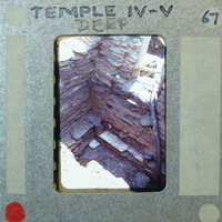 Small stone room with tall walls and modern hose from the upper right for drainage.