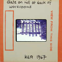 A vintage photo of a wooden bridge with handwritten notes on the front and back.